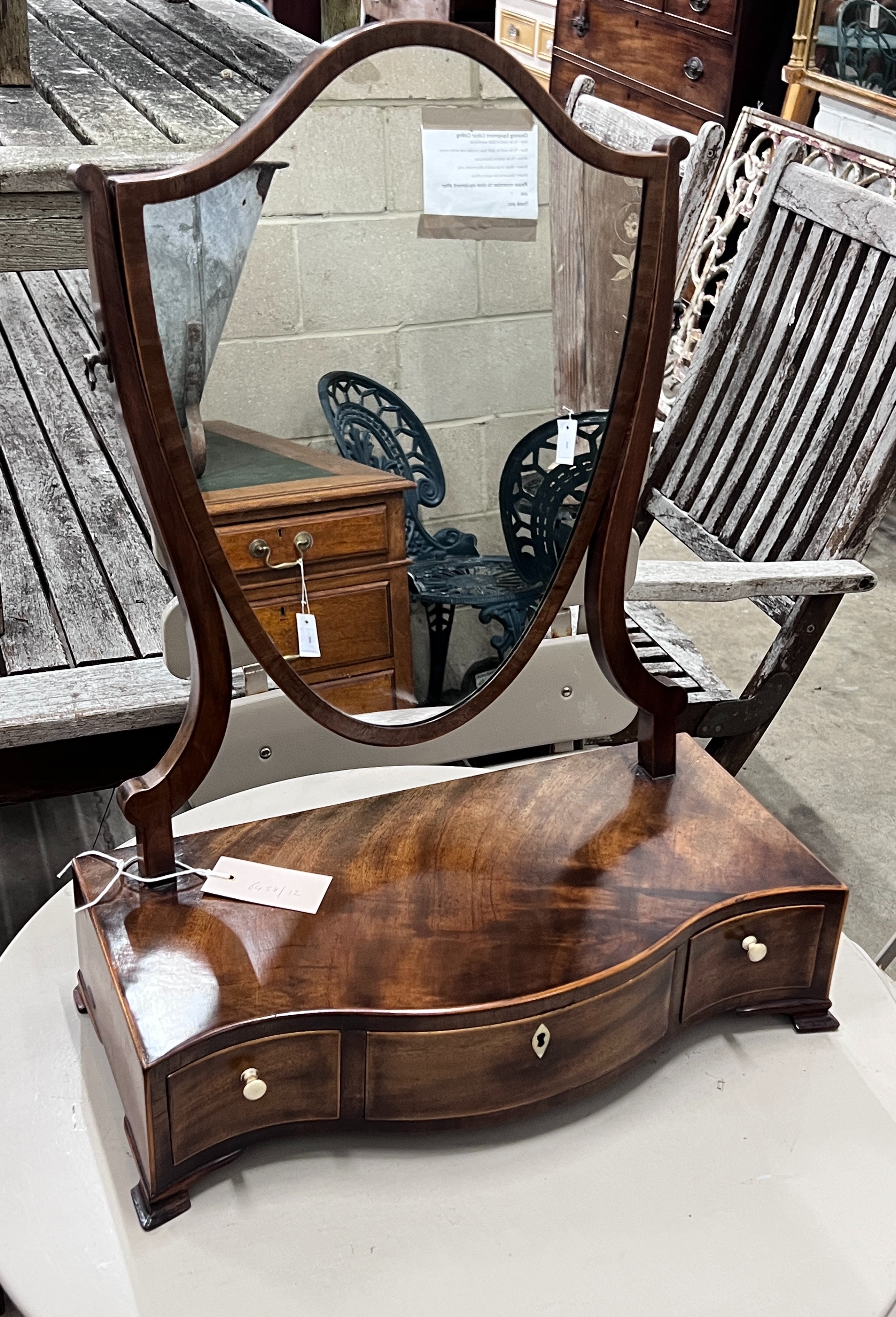 A George III serpentine mahogany box base toilet mirror, width 43cm, depth 21cm, height 57cm